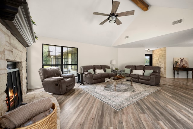 living room featuring ceiling fan, beam ceiling, a healthy amount of sunlight, and a fireplace