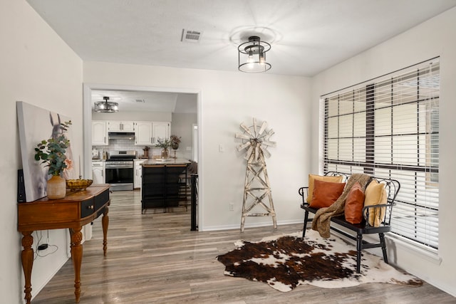 sitting room featuring hardwood / wood-style flooring and plenty of natural light