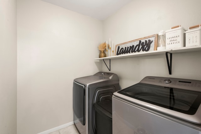 washroom with washer and dryer and light tile patterned flooring