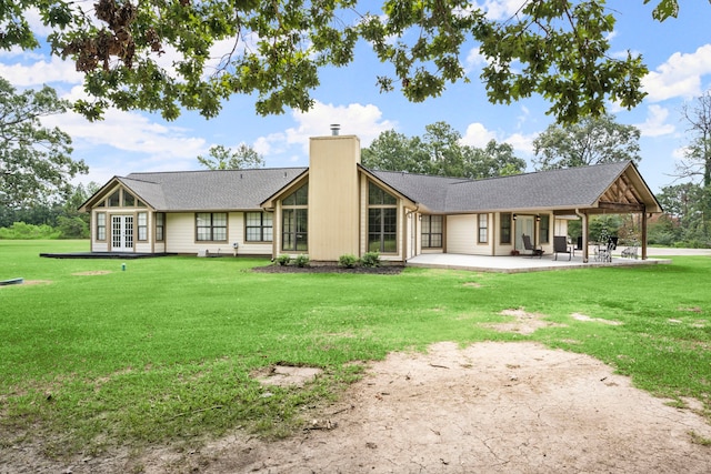 back of house featuring a patio area and a yard