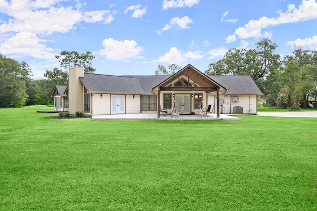 craftsman inspired home featuring central air condition unit, french doors, a patio, and a front yard