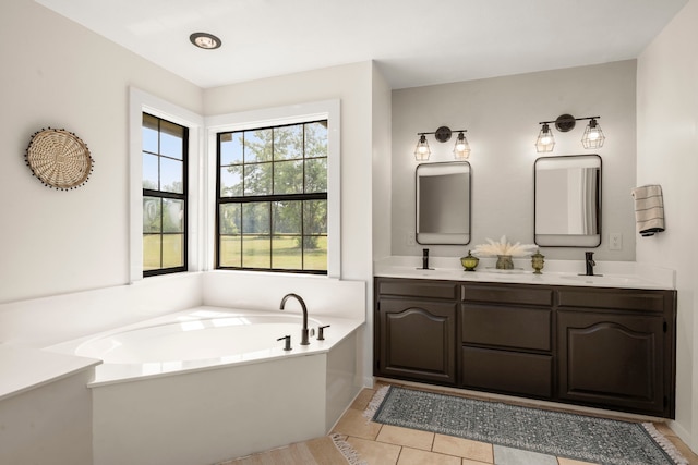 bathroom with tile patterned floors, vanity, and a bathing tub