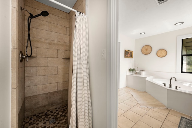 bathroom featuring tile patterned flooring and shower with separate bathtub