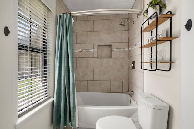 bathroom featuring shower / bathtub combination with curtain and toilet