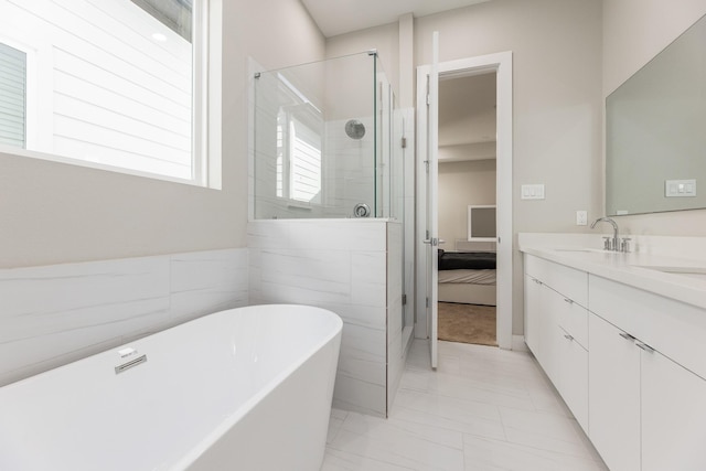 bathroom featuring vanity and shower with separate bathtub