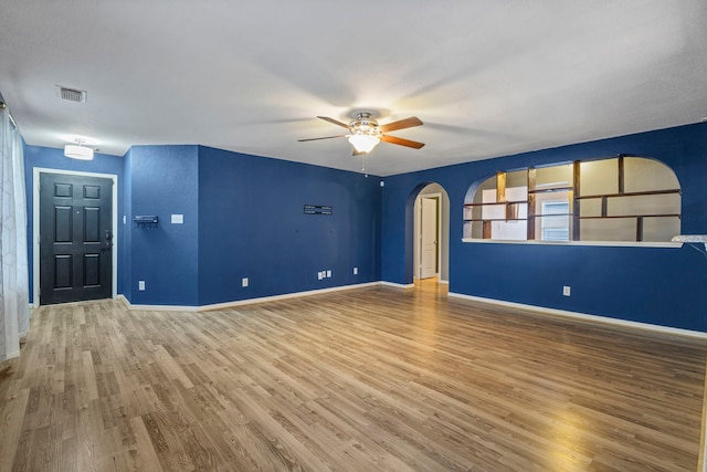 unfurnished room with ceiling fan and hardwood / wood-style floors