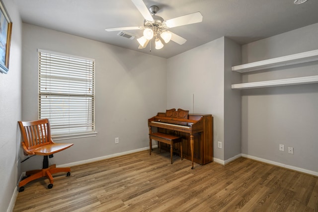 misc room with hardwood / wood-style floors and ceiling fan