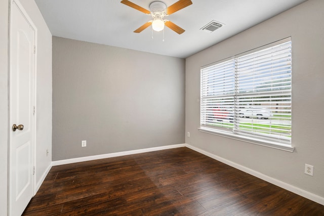 empty room with ceiling fan and dark hardwood / wood-style floors