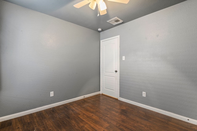 spare room featuring ceiling fan and dark hardwood / wood-style flooring