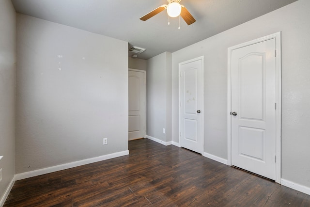 unfurnished bedroom featuring ceiling fan and dark wood-type flooring