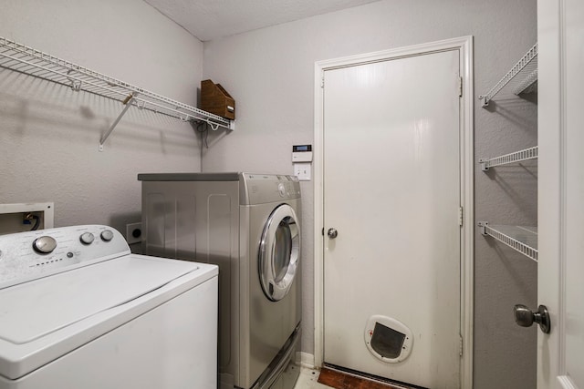 laundry area with separate washer and dryer