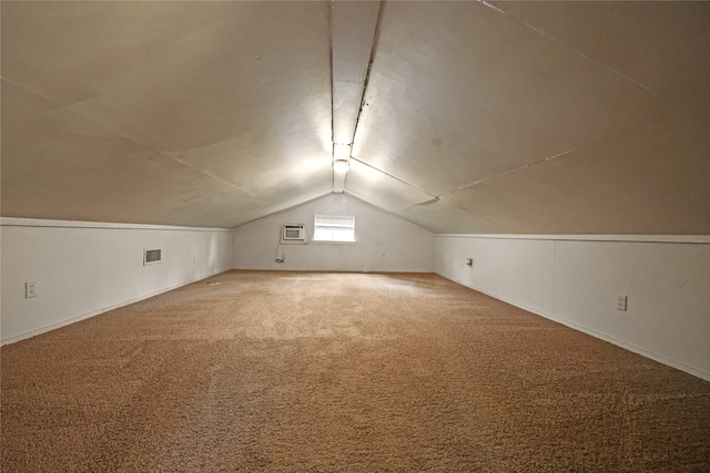 bonus room with carpet, a wall mounted air conditioner, and lofted ceiling