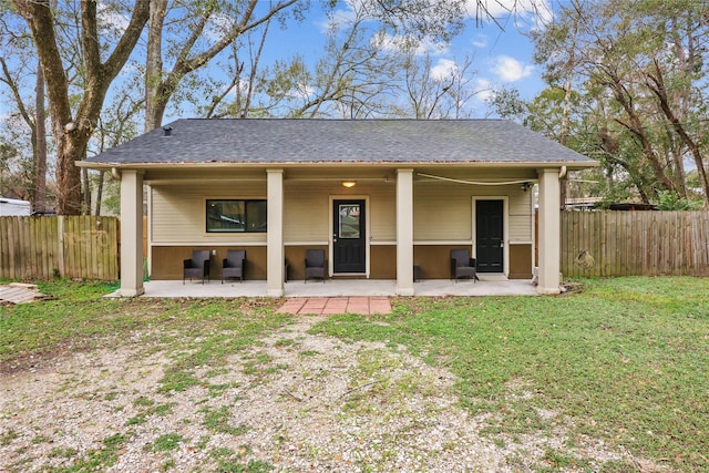 rear view of house featuring a patio and a lawn