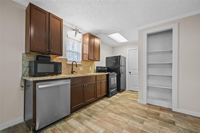 kitchen featuring sink, built in features, a textured ceiling, black appliances, and ornamental molding