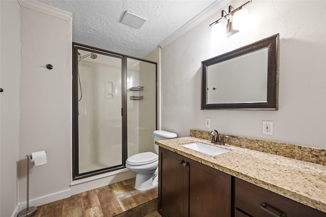 bathroom featuring vanity, a textured ceiling, hardwood / wood-style floors, toilet, and a shower with shower door