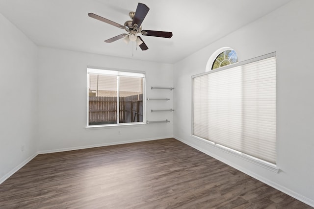 unfurnished room featuring ceiling fan and dark wood-type flooring