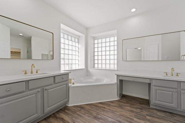 bathroom featuring a bathtub, vanity, and wood-type flooring