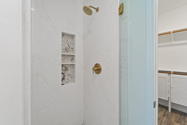 bathroom featuring hardwood / wood-style flooring and walk in shower