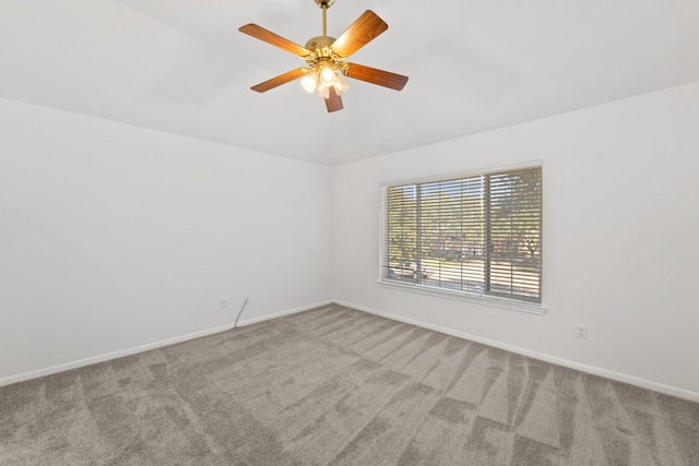 spare room featuring light colored carpet and ceiling fan