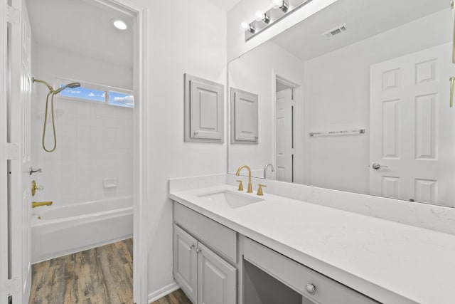 bathroom featuring vanity,  shower combination, and wood-type flooring