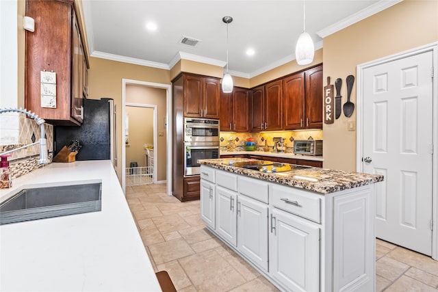 kitchen featuring black electric stovetop, white cabinets, sink, decorative backsplash, and stainless steel double oven