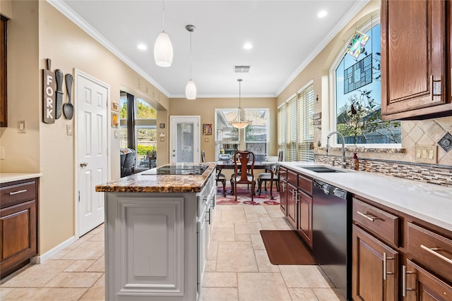 kitchen featuring pendant lighting, a center island, backsplash, black appliances, and sink