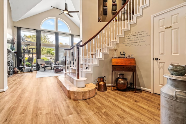 entrance foyer with ceiling fan, light wood-type flooring, and high vaulted ceiling