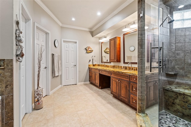 bathroom with tile patterned floors, a shower with door, vanity, and ornamental molding