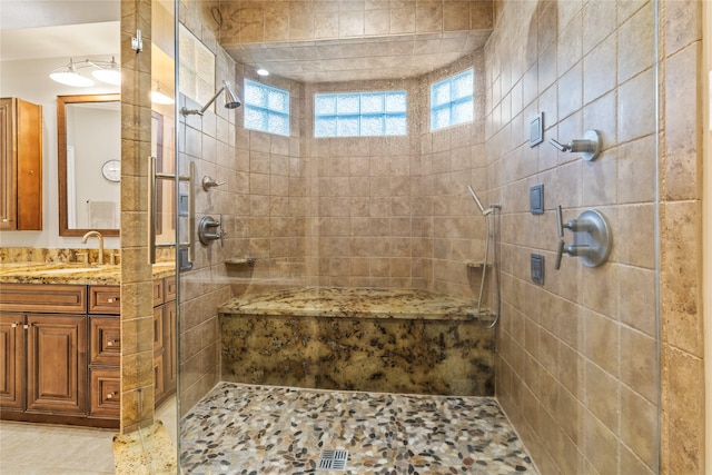 bathroom featuring vanity and a tile shower