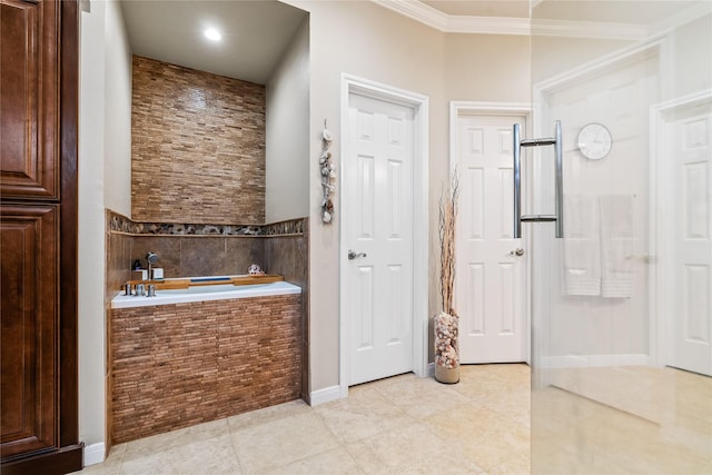 bathroom featuring tile patterned flooring, tiled bath, and ornamental molding