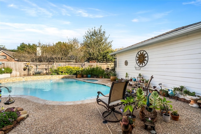 view of pool with a patio area and an in ground hot tub