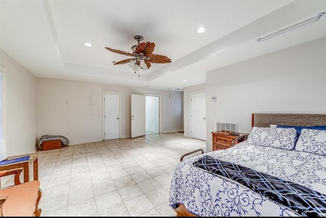 bedroom featuring a tray ceiling and ceiling fan