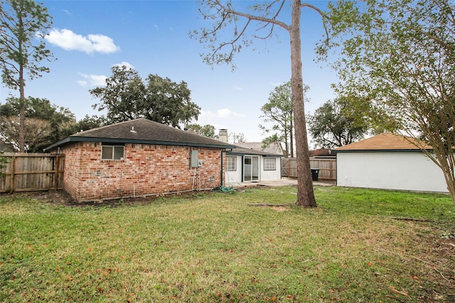 rear view of property featuring a yard