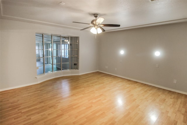 spare room featuring ceiling fan and light wood-type flooring