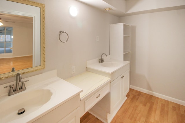 bathroom featuring hardwood / wood-style floors, ceiling fan, and vanity