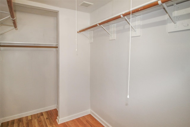 spacious closet featuring hardwood / wood-style flooring