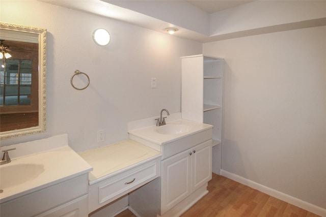 bathroom with ceiling fan, wood-type flooring, and vanity