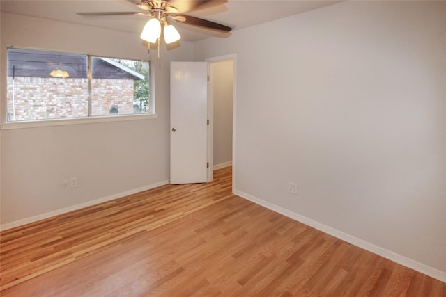 spare room with light wood-type flooring and ceiling fan