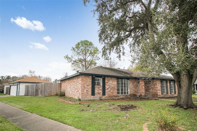 single story home with a front yard and a garage