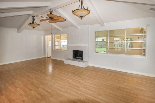 unfurnished living room with vaulted ceiling with beams, ceiling fan, a fireplace, and hardwood / wood-style flooring