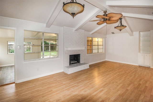 unfurnished living room with a fireplace, lofted ceiling with beams, light hardwood / wood-style floors, and ceiling fan