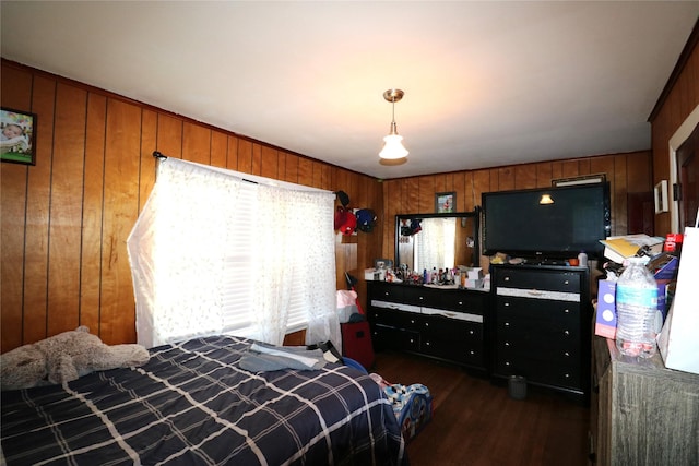 bedroom with dark wood-type flooring and wooden walls