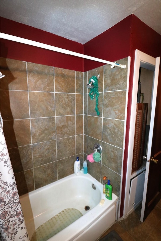 bathroom featuring shower / bath combination with curtain and a textured ceiling