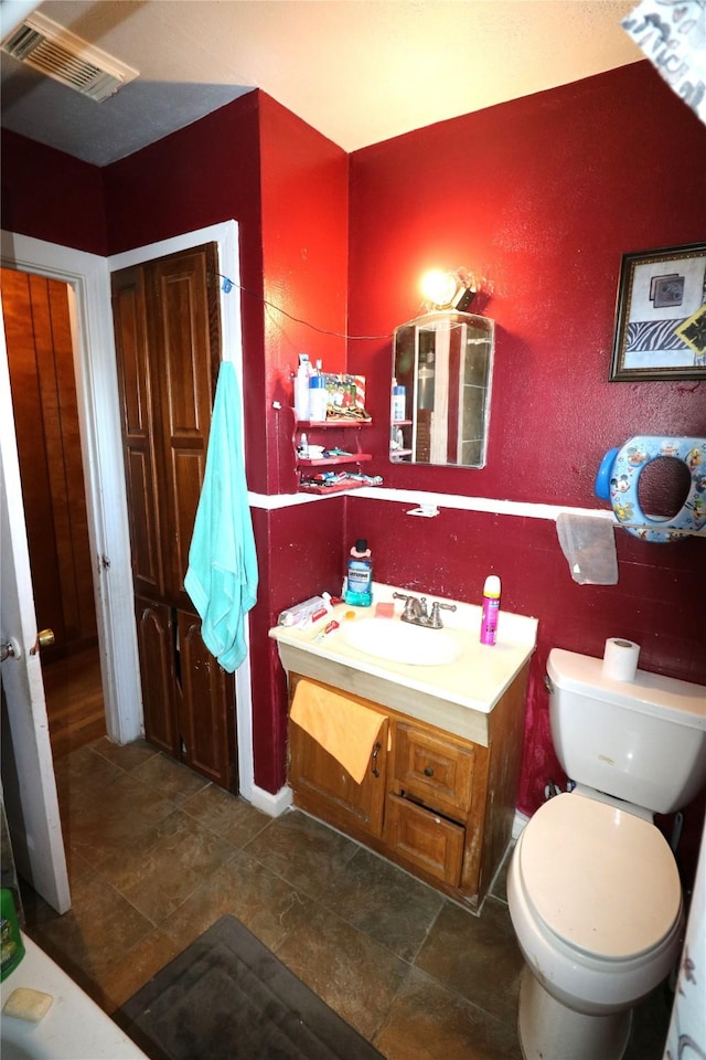 bathroom with vanity and toilet