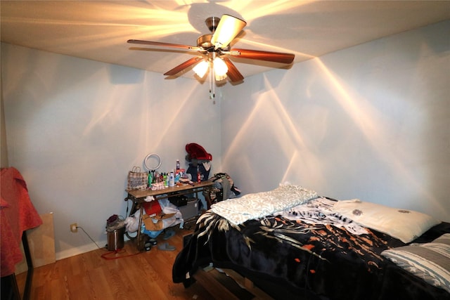 bedroom featuring ceiling fan and wood-type flooring