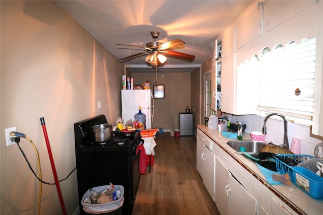 kitchen featuring sink, white refrigerator, electric range, white cabinets, and dark hardwood / wood-style floors