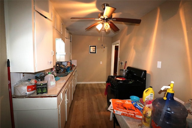 kitchen with ceiling fan, white cabinetry, dark wood-type flooring, and black gas range oven