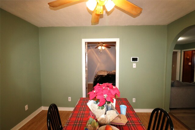 dining area with hardwood / wood-style flooring and ceiling fan