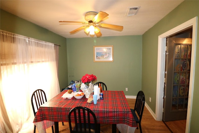 dining area featuring ceiling fan and wood-type flooring