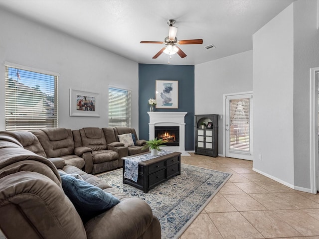 tiled living room featuring ceiling fan